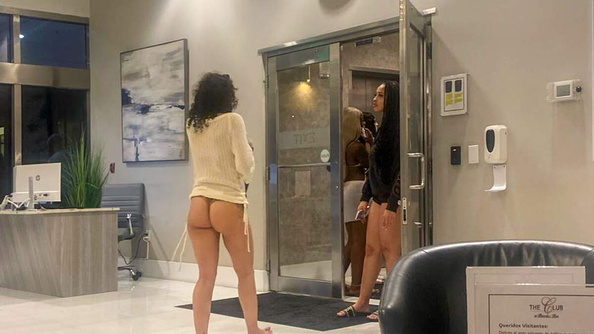 A thong-wearing woman in the lobby at The Club at Brickell Bay in Miami. Signs posted in the building’s elevators say short-term tenants need to ‘maintain a respectful dress code in the common areas.’ Longtime homeowners at The Club have been battling their HOA board over investors renting out their units to short-term vacation tenants.